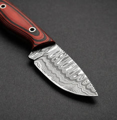 Knife with a red and black handle on a dark gray background