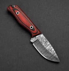 Knife with a red handle on a dark gray background