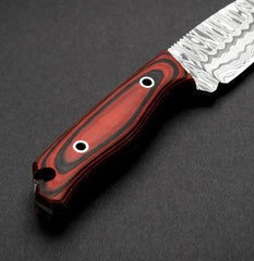 Knife with a red and black handle on a dark gray background