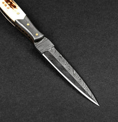 Decorative knife with a detailed blade on a dark background