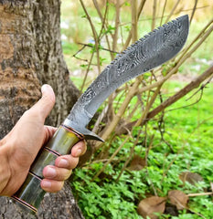 Hand-forged kukri blade in hand