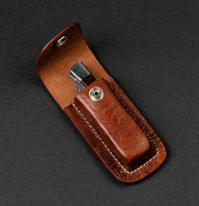 Brown leather case with a silver clip on a dark gray background