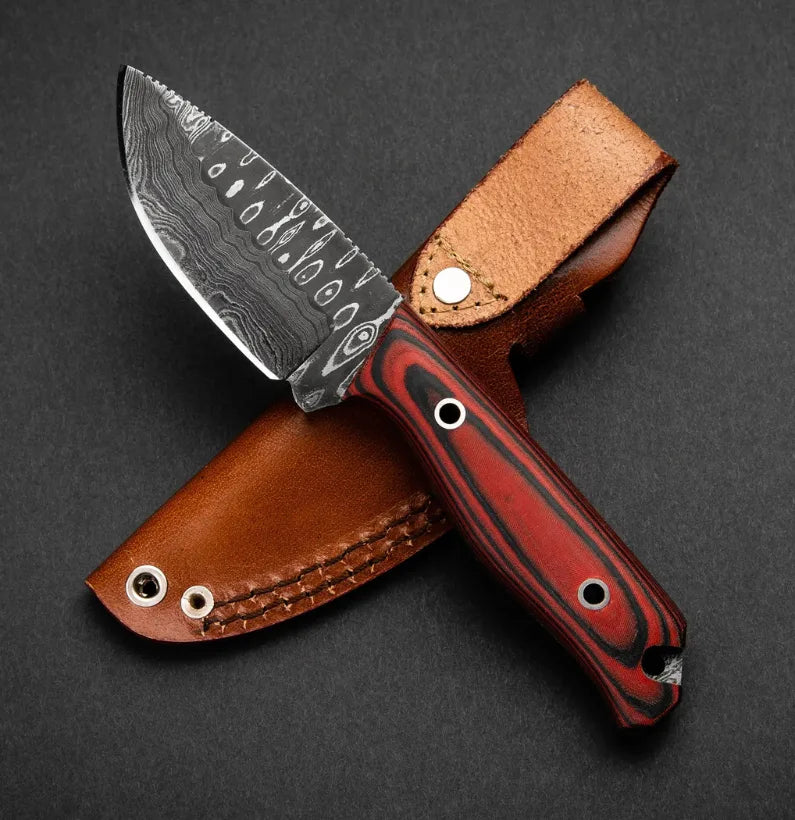 Knife with a red handle and brown leather sheath on a dark background
