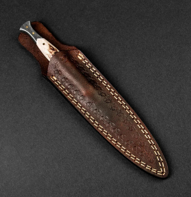 Brown leather knife sheath with stitching on a dark gray background