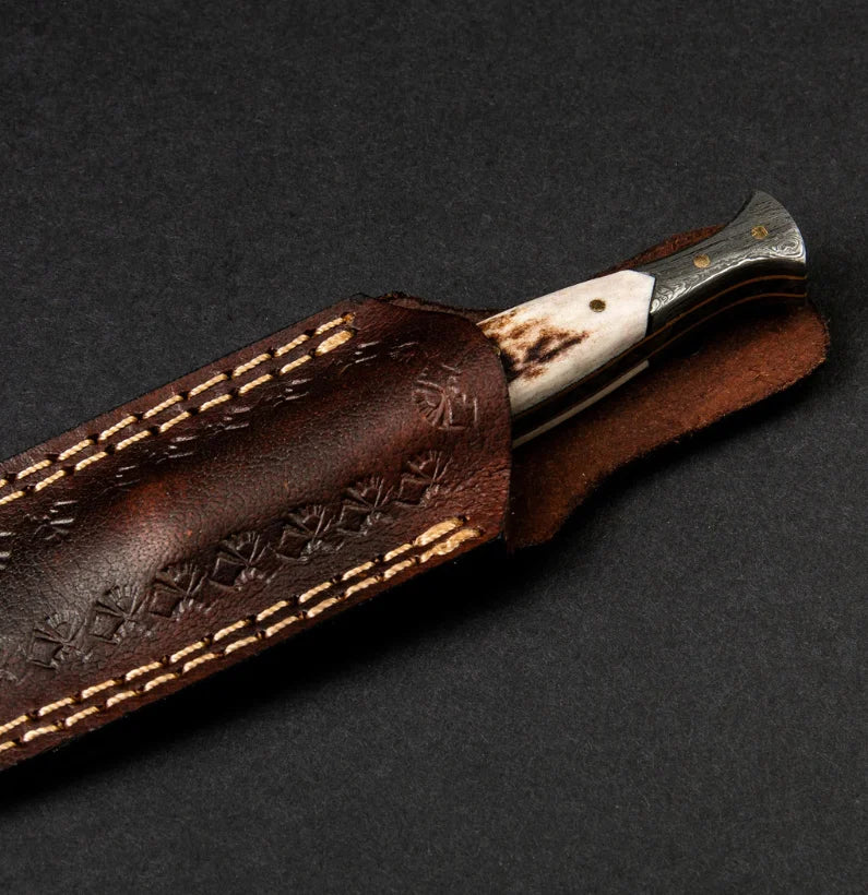 Knife with wooden handle and leather sheath on a dark background